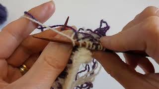 Weave in the contrast color in stranded knitting - both yarns in the left hand