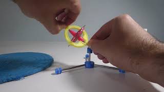 DRILL POWER Small Toy Gyroscope with Rubber Stem on Rotating Base. Pause 0:30. Rises 0:40 Falls 1:30
