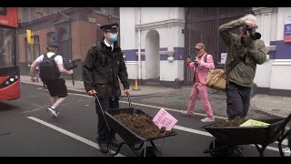 Police Officers Guard Piles Of Manure As Protest Hits Murdoch Hq In London