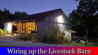 Wiring up electricity in the livestock barn.  Power and lights for the livestock.