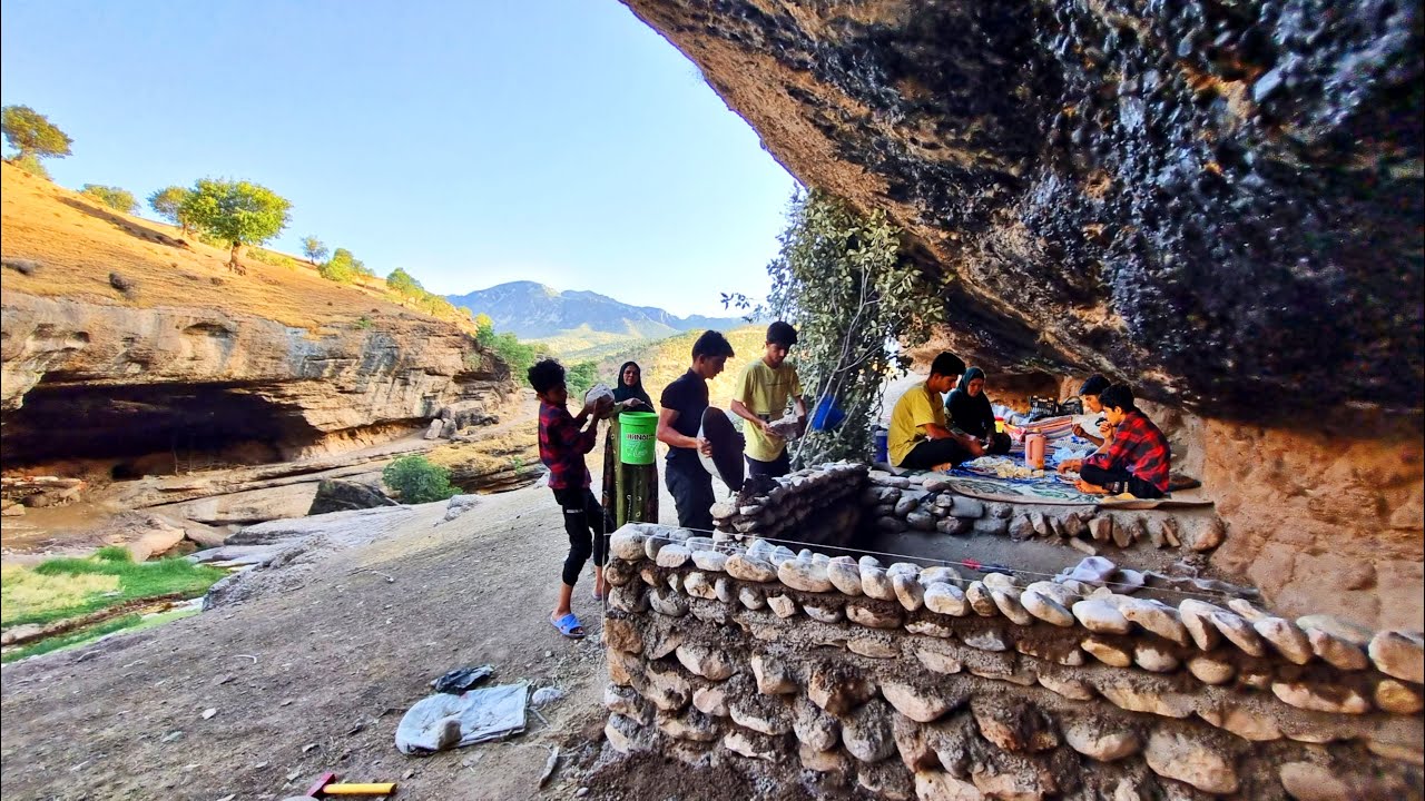 Nomadic lifestyle with mother cooking with firewood and building a ...