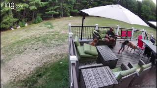 Girl uses VR virtual reality glasses and falls on wood deck in backyard (Security camera)