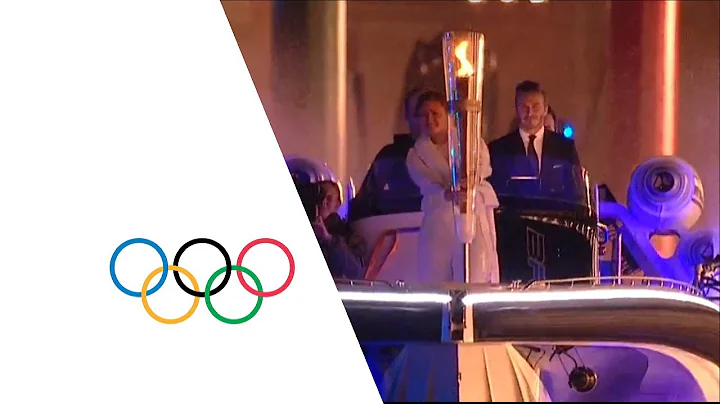 David Beckham & Sir Steve Redgrave Pass Olympic Torch - London 2012 Opening Ceremony