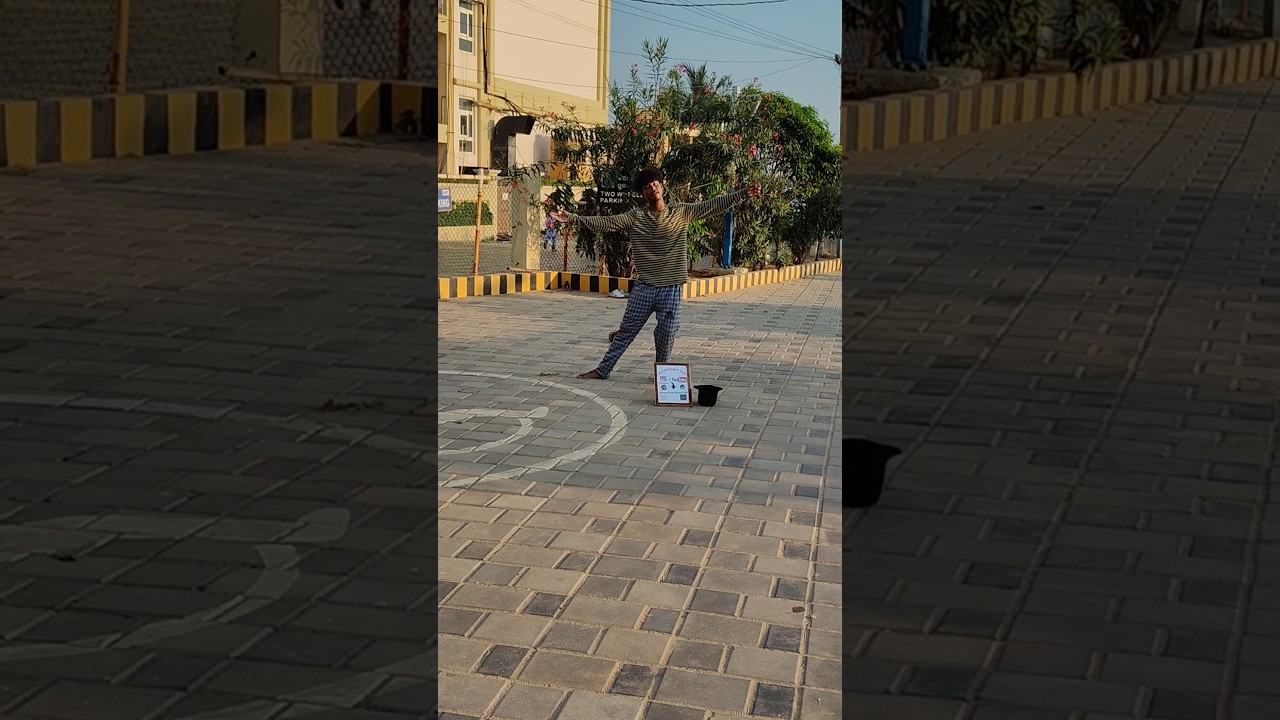 Young boy dancing in street for money  