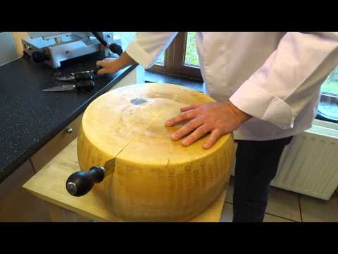 opening a wheel of parmesan cheese (parmigiano reggiano)