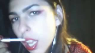 A sexy girl is applying hot red lipstick