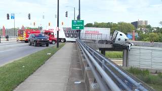 A semi-truck was left dangling from an overpass in Cincinnati over the weekend