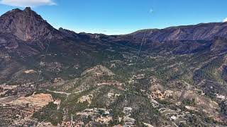 Aerial perspective of canyon with geologist studying diverse geological formations and terrain