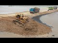 Dump Trucks unloading dirt & Bulldozers pushing dirt