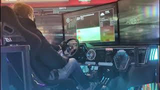 Driving the Nurburgring gp track on a simulator running asseto corsa in an amusement arcade