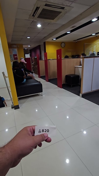 in-filipino-bank-waiting-to-exchange-money-into-pesos-shorts-the
