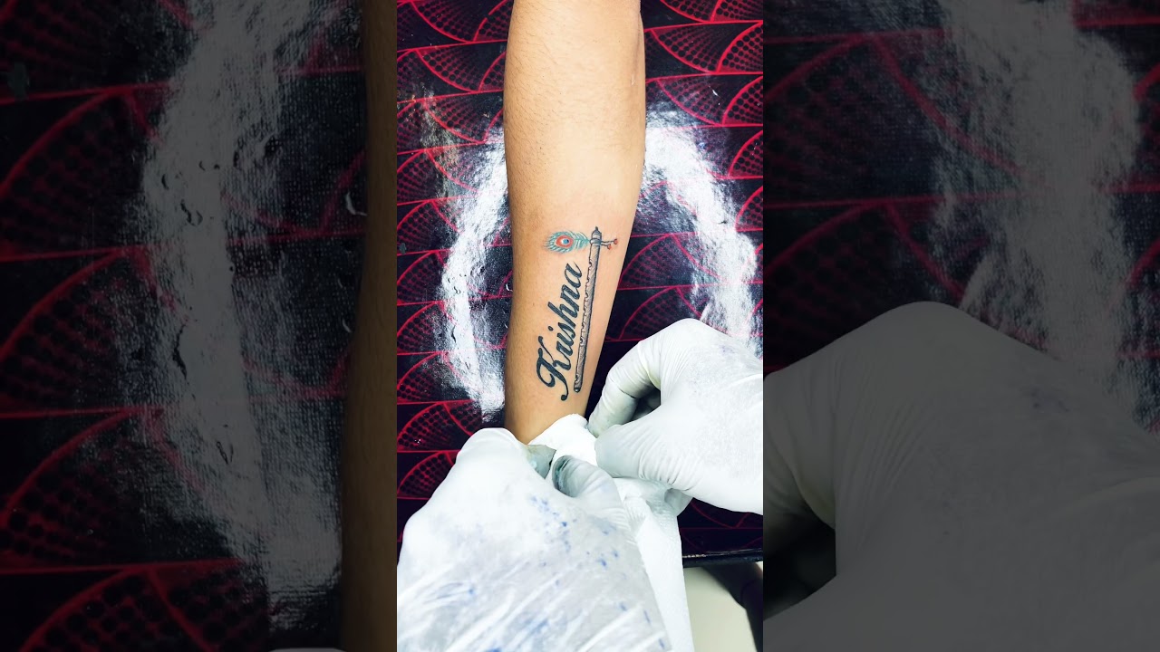 Krishna name flute tattoo 