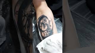 Clock with compass tattoo