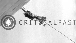 U.S. Navy sailor Charles Cowart dangles from USS Akron's mooring line, 1932
