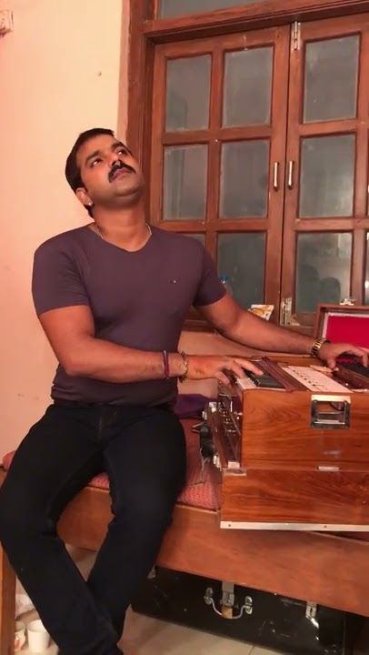 Pawan singh while playing harmonium