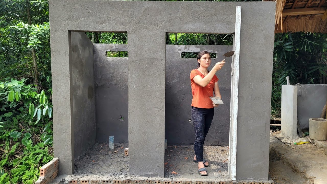 Plastering toilet and bathroom walls with cement and fine sand for ...