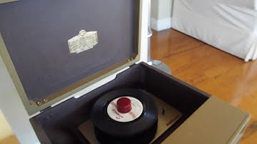 RCA automatic 45 record player playing a stack of records.