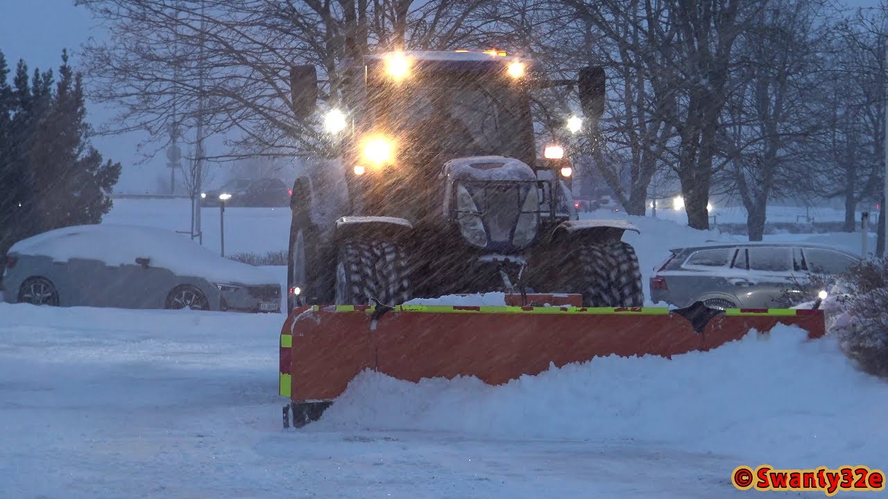 4K| New Holland T7.250 Plowing Snow In A Parking Lot