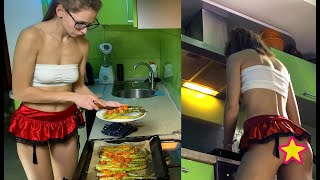 Girl cooking asparagus in short skirt