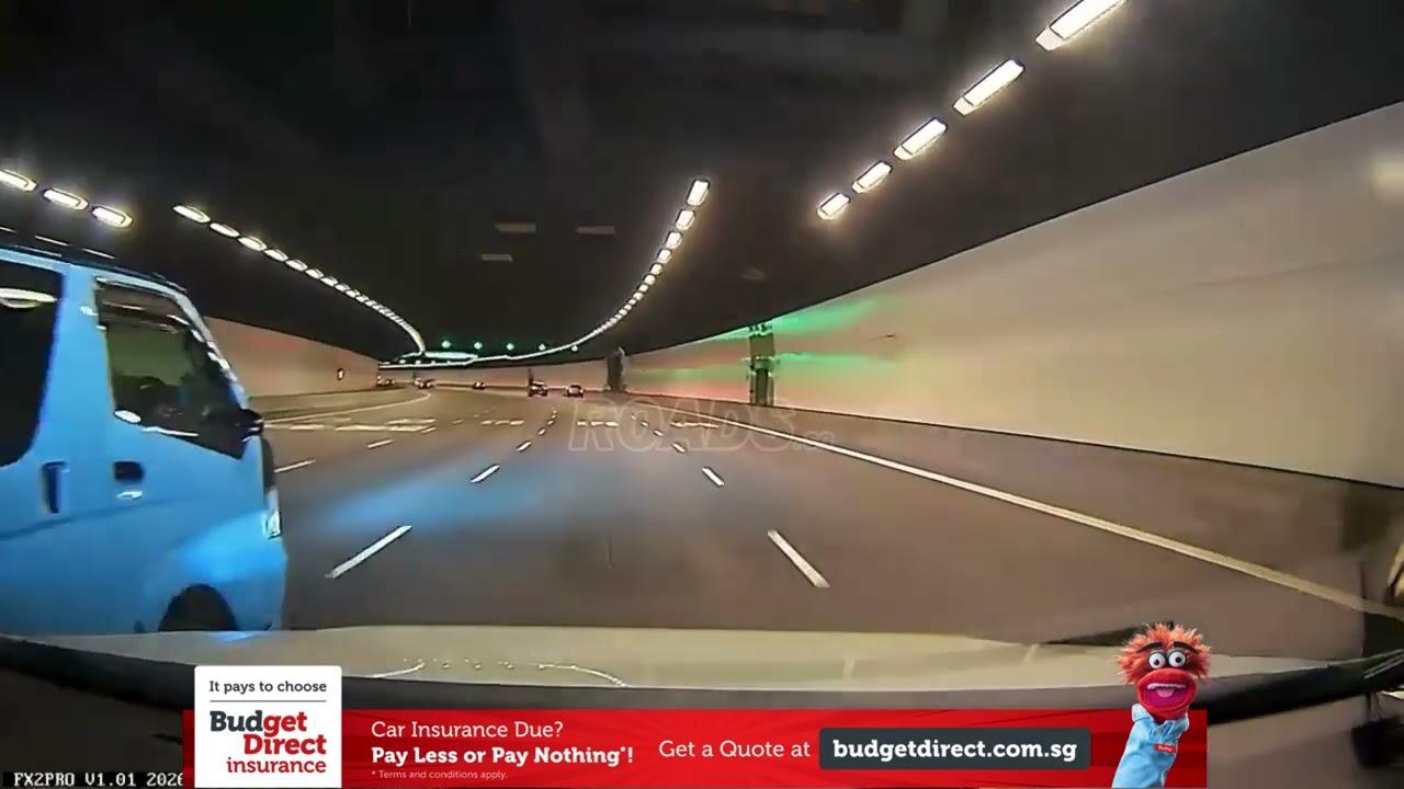 Van driver changing lanes without signal or checking blind spot, almost colliding into cam car.