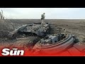 Ukrainian soldiers inspect destroyed, recovered Russian tanks and vehicles