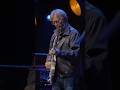 Eric Clapton performing "While My Guitar Gently Weeps" alongside Peter Frampton.