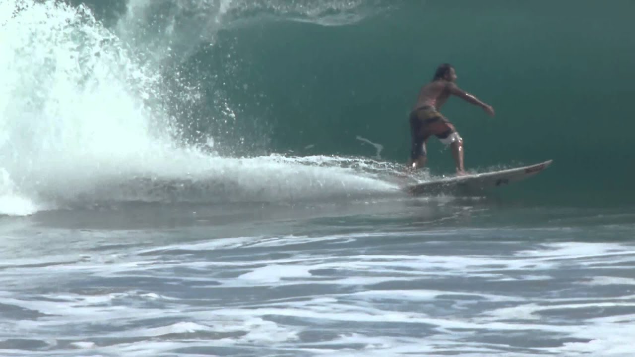 Local Surf Pro Chino rides nice wave at Playa Espadilla, Manuel Antonio