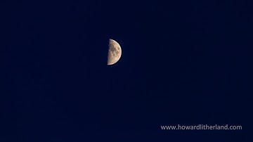 Time lapse of a quarter moon dropping through a darkening sky