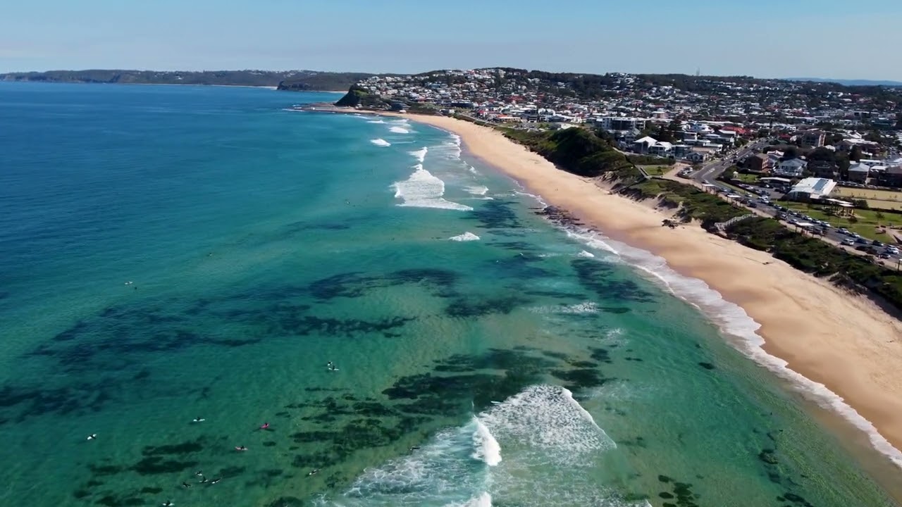Aerial drone surfing ocean swimming paddle beach Merewether Bar Beach NSW Newcastle Australia