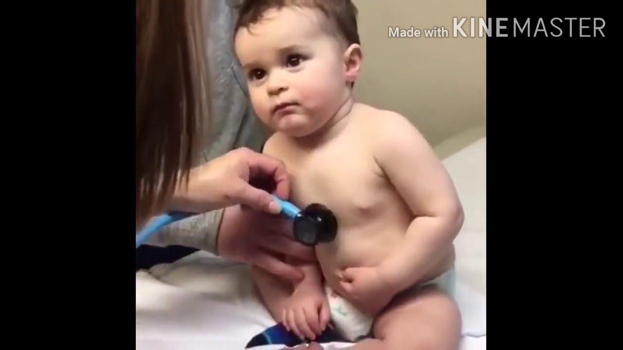 Baby boy resting head on nurse hand