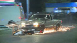 Pickup plows through protester crowd, drags motorcycle