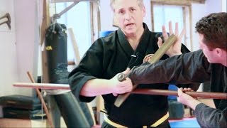 Wielding the Tonfa: Utilizing Grappling Techniques to Release the Grip on a Bo