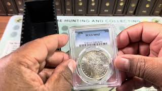 Coin collector in 2025 with a PCGS unboxing a Morgan Silver Dollar submission