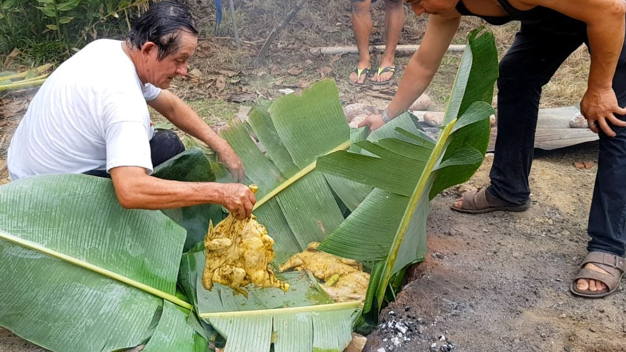 Peru. Chickens Roasted Underground with Hot Stones. Preparing