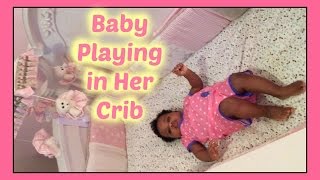 Baby Playing In Her Crib