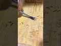 Carving the interior surface of a custom wooden box with a sharp gouge chisel tool to add texture