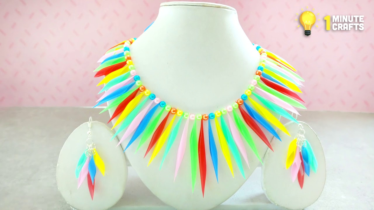 Colorful craft jewels and straw hats on sale. Hanging plastic and