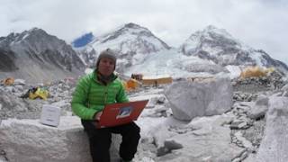 Alpinist Atanas Skatov browsing the internet thanks to Thuraya IP+ at Base Camp Everest