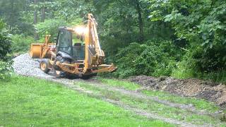 Case 580 Super N Digging in the Rain