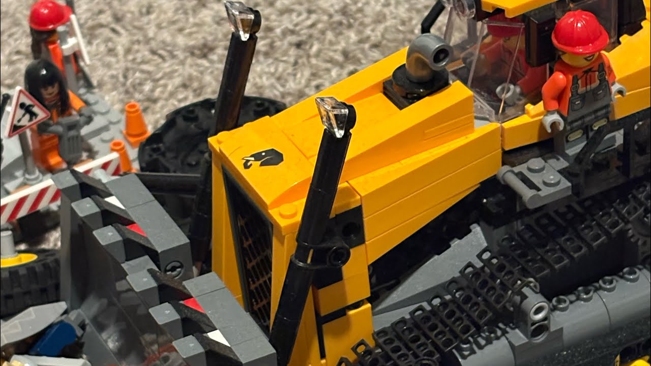 Construction crew and heavy machinery hard at work, clearing debris and breaking ground.