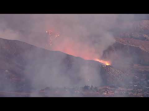 Crews battle massive brush fire surrounding homes in Riverside County