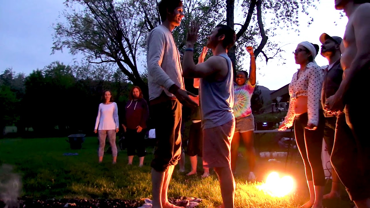 Residents of Sunrise Ranch walking on hot coals.
