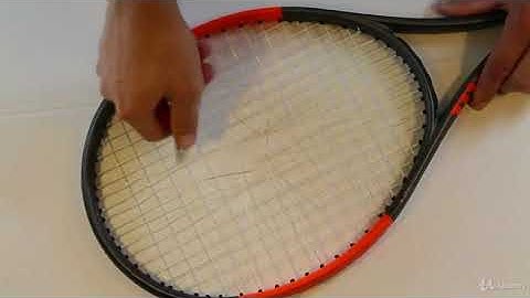 How to String a Tennis Racket : Cutting out the old strings