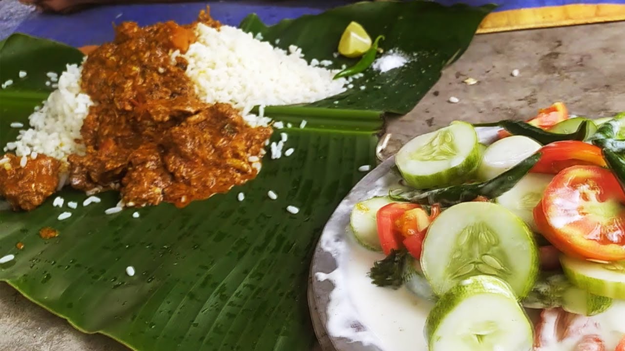 Chicken curry and rice feast in jungle near waterfall