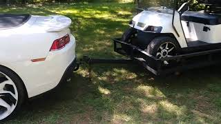 Camaro towing a golf cart