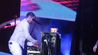 Joe Jonas playing piano and Nick Jonas eating popcorn. Raleigh 7/31/13
