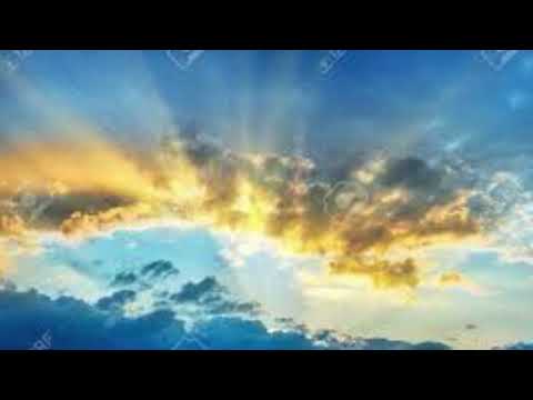 I watch the sunlight shining through the clouds.