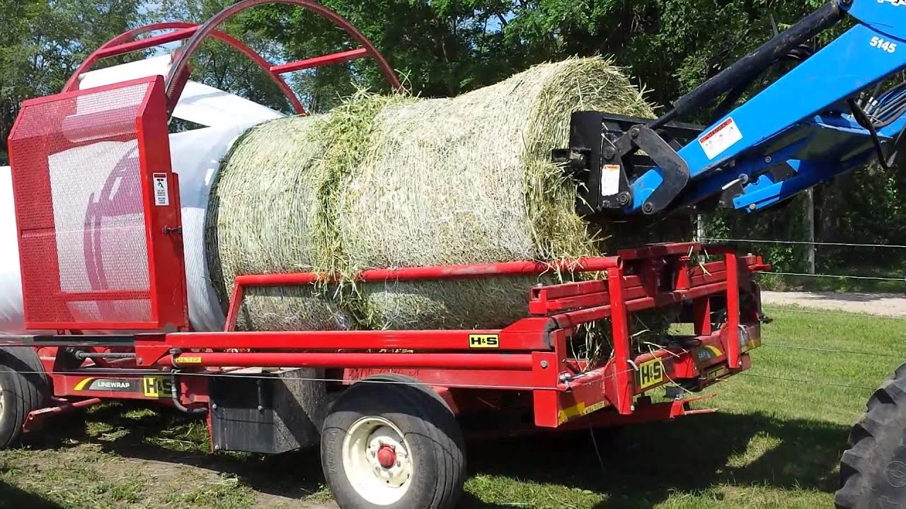 H&S bale rapper putting plastic on silage bales. YouTube