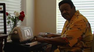 Fats Domino playing piano at home