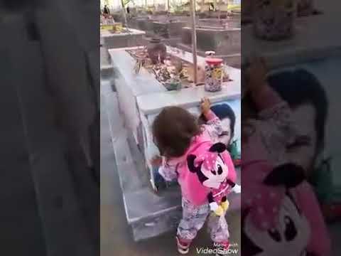 A girl child kiss her dad's photo at Syria